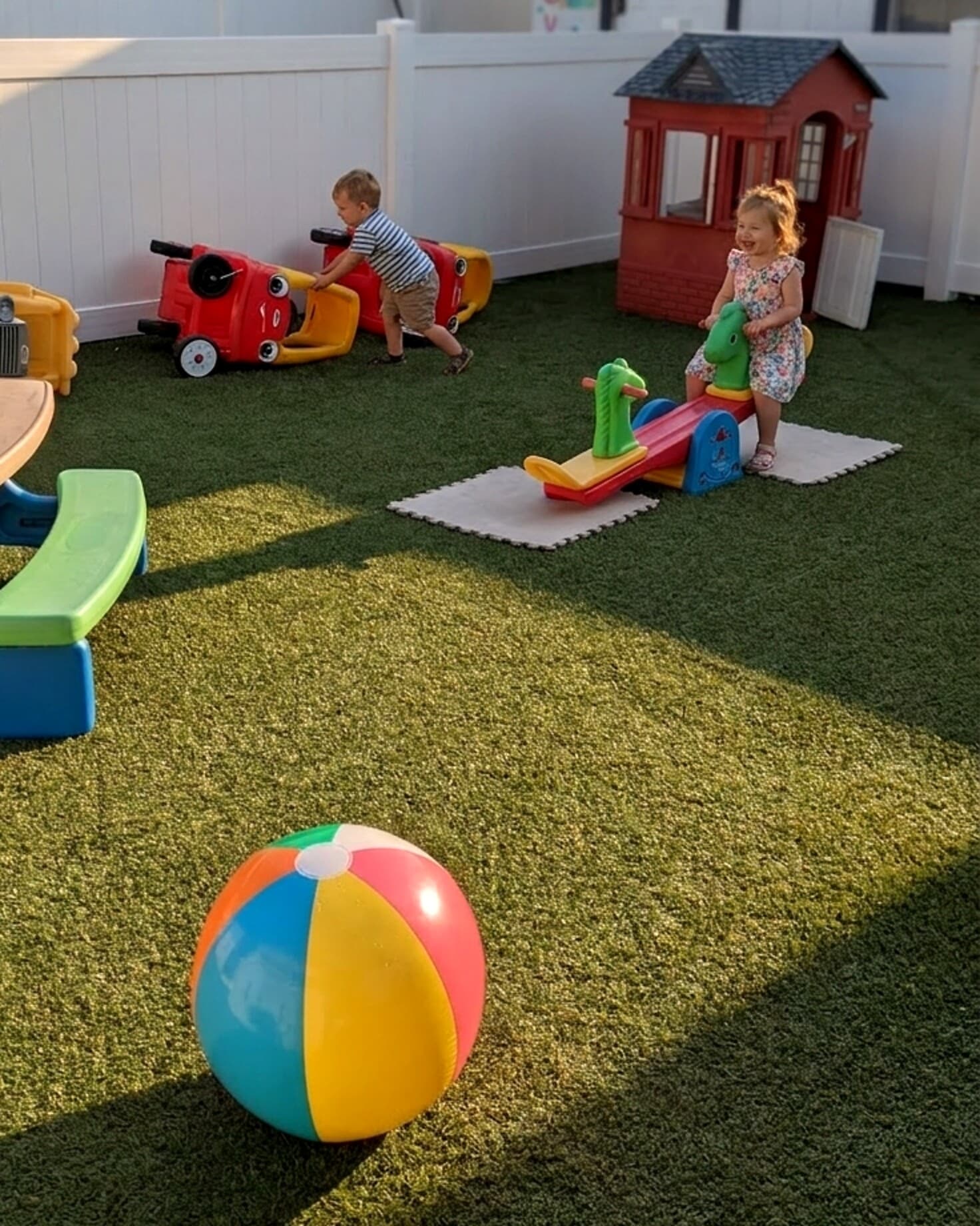 The fenced backyard play area at Oni's Happy Hearts on a sunny day