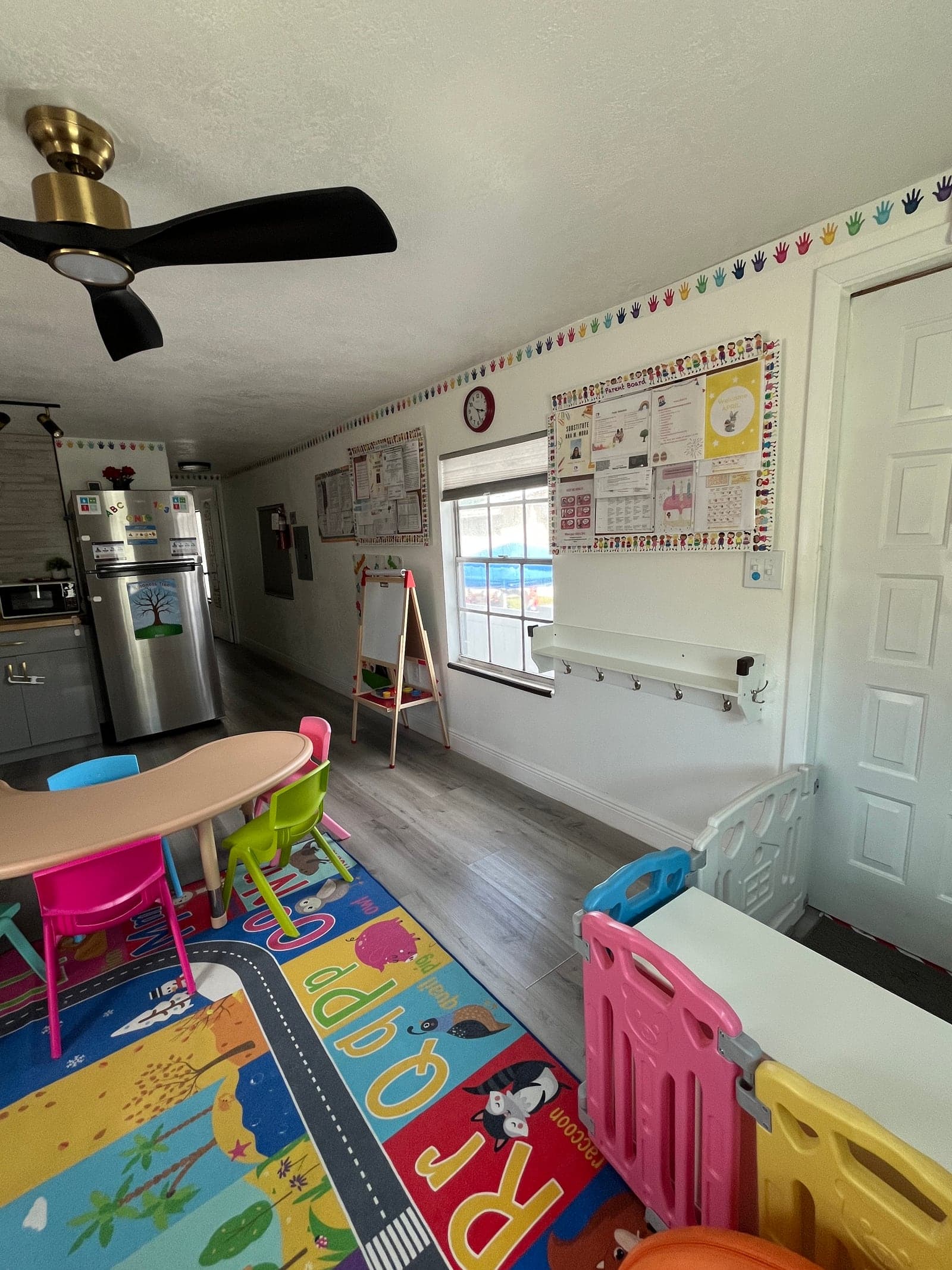 Early education corner with learning charts at Oni's Happy Hearts
